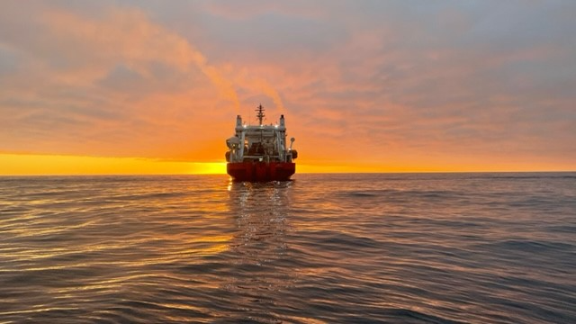Cable ship at sunset on open water